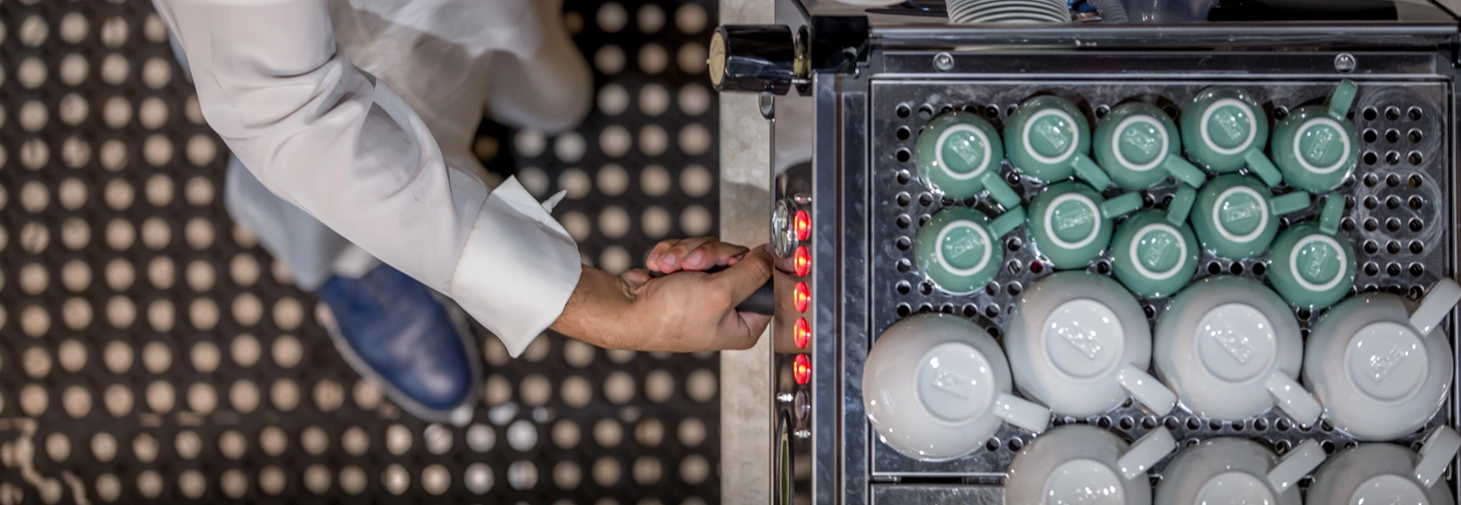 A person locks a portafilter into an espresso machine.